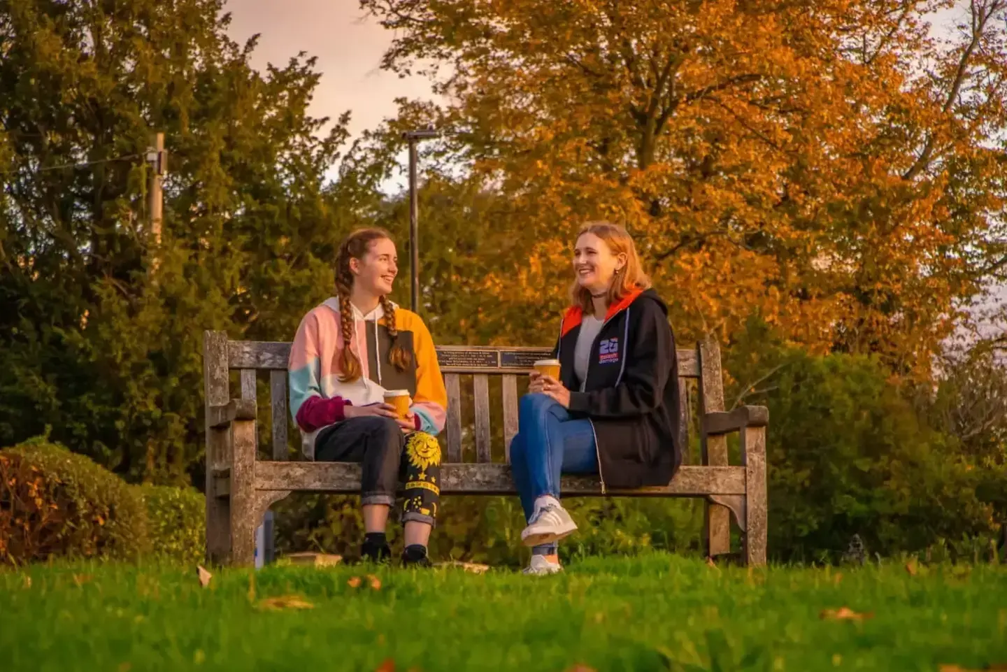 Two Splash employees sitting on the bench in a park